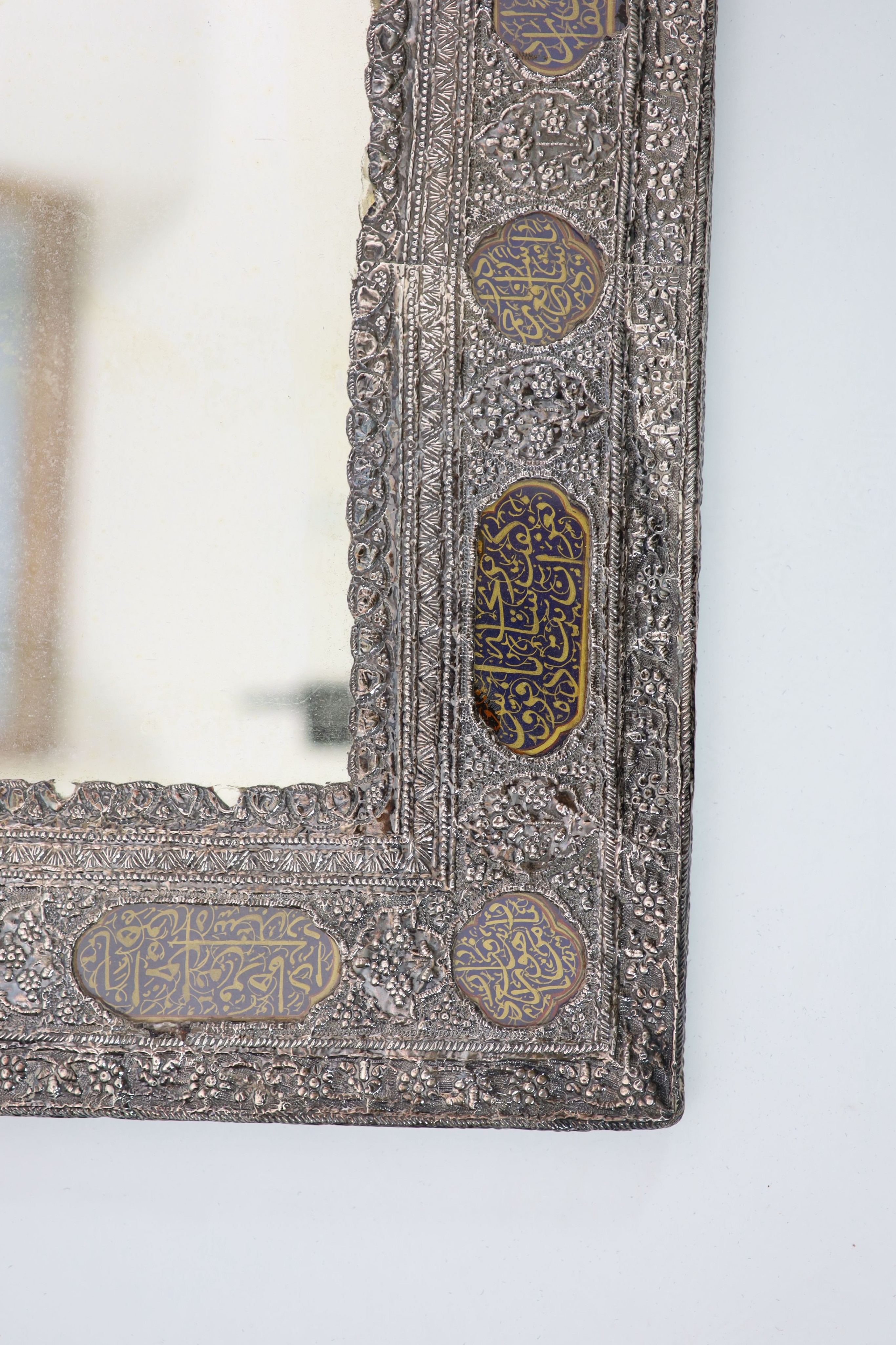 A Persian repousse white metal wall mirror, first half 20th century,